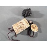 A vintage Japanese bone Inro and button Netsuke depicting an oriental gentleman on both sides of