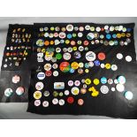 A collection of approximately 160 pin badges of varying subjects.