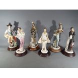 Six figurines on wooden bases to include Vittorio Tessaro and similar,