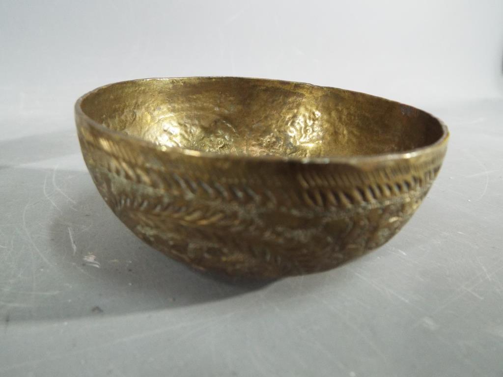 Four middle eastern metal dishes, comprising four bowls and a cup having chased decoration. - Image 5 of 6