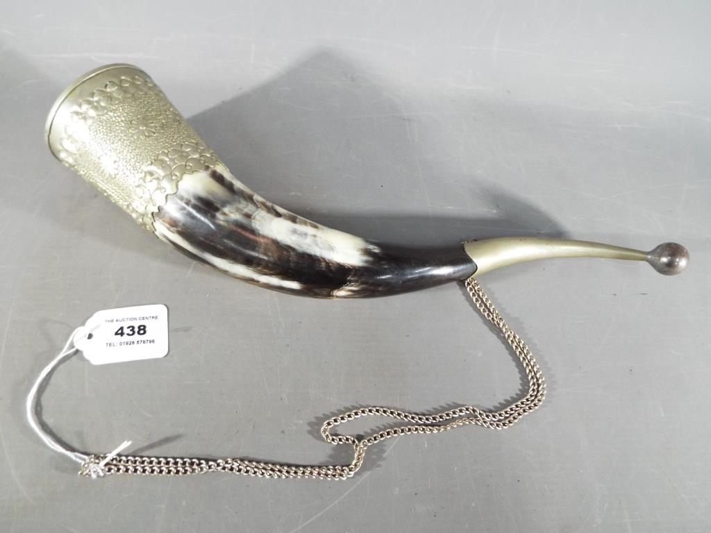 A huntsman's Drinking Horn, with white metal mounts and safety chain, approx 38 cm long.