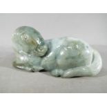 A Chinese green jade carving of a recumbent horse,