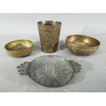 Four middle eastern metal dishes, compri
