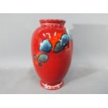 Poole Pottery - A Poole Pottery ceramic vase with abstract design on a red ground,