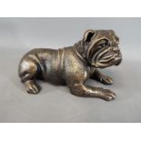 A cast iron bulldog in a lying position (WBULD), approx 14 cm (h) x 25 cm (l), weight approx 3 .