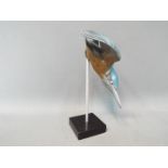 A cold cast model depicting a diving Kingfisher, mounted on plinth,