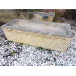 A stoneware rectangular trough decorated with scrolls of oak leaves,