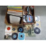 Two boxes containing a quantity of 33 and 45 RPM vinyl records to include Bob Dylan, The Troggs,