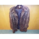 A brown 3/4 length fur coat,