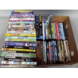 A box containing a quantity of DVD's and Blu Ray discs including comedies,