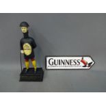 A cast iron sign marked Guinness and a related cast iron money bank. [XGUI2].