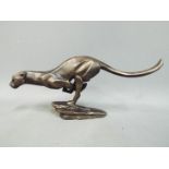 A cast figurine depicting a running cheetah.