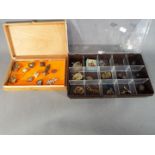 Military - two boxes containing a quantity of military cap badges, pips, pin badges,