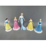 Royal Doulton - Five Royal Doulton figurines comprising four from the Disney Princesses series,