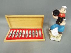 Popeye - A wooden 'Novelty Cutlery Collectors Case' containing ten Popeye folding penknives and a