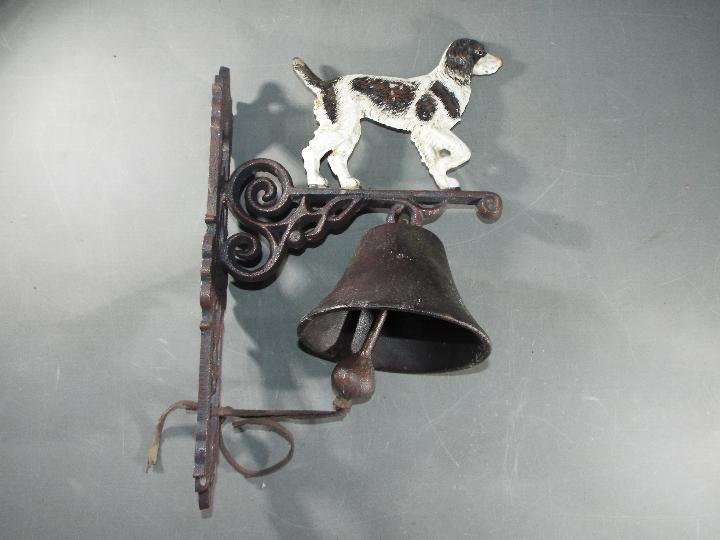 A cast bell with a depiction of a Springer Spaniel approximately 38cms (H)x 15cms (W) x 23cms (D)