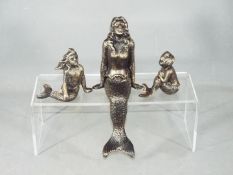 A cast Mermaid family set.