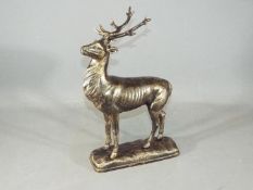 A cast figure of a deer on a base, standing approximately 30 cms in height.