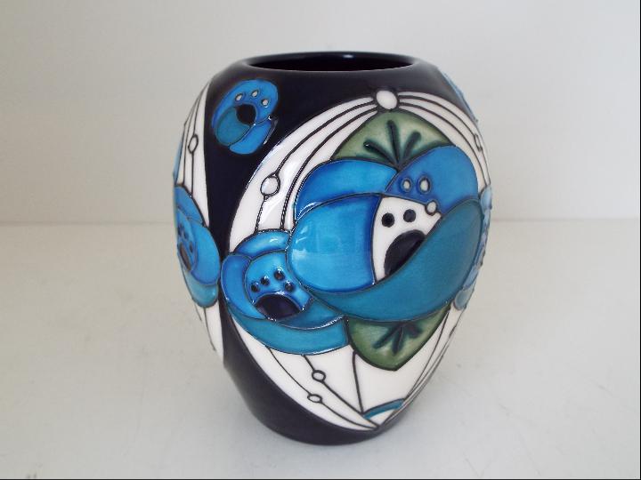 Moorcroft Pottery - a vase decorated in the Rose Blue pattern, approximately 7.