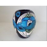 Moorcroft Pottery - a vase decorated in the Rose Blue pattern, approximately 7.