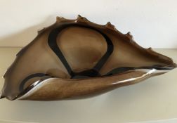 A heavy good quality art glass centrepiece in black and brown tones in the form of a sea shell,