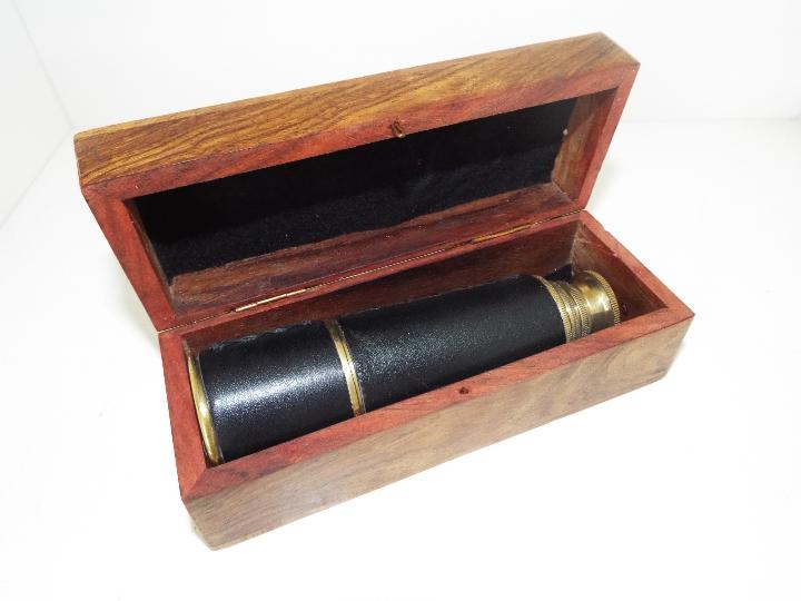 A leather bound, three-draw brass telescope, in hinge-lidded hard wood case, the case measuring 5. - Image 2 of 2