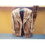 A lady's fur coat, approximately 100 cm (l), slip pockets, a tear to the lining to one shoulder,