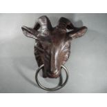 A cast goat head with ring (xgoat)