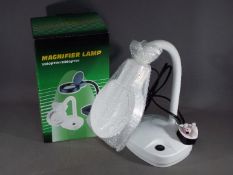 A small table magnifier lamp.