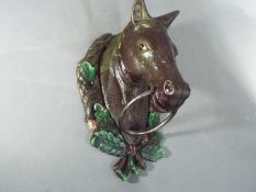 A cast horse head door knocker (XHHD)