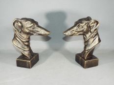 A pair of cast Greyhound heads each measures approximately 23 cms in height.
