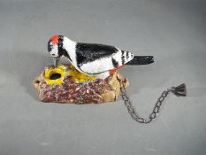 A cast woodpecker doorknocker.
