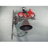 A cast bell with a depiction of a motorcyclist and veteran motorcycle approximately 38cms (H)x