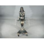 A cast metal mermaid figure measuring approximately 50 cms in length.