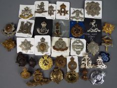 A collection of military cap badges and similar.