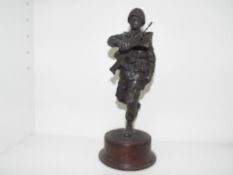 A cold cast bronze figurine depicting a uniformed military figure mounted on a plinth,