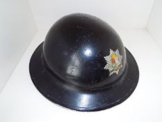 A World War Two (WW2) helmet with crested decal marked 'East Ham Fire Brigade',