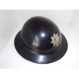 A World War Two (WW2) helmet with crested decal marked 'East Ham Fire Brigade',