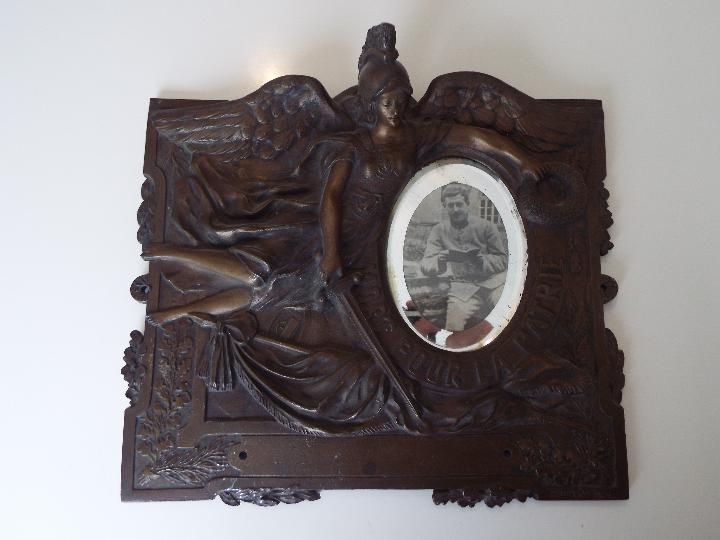 A metal wall plaque with embossed decoration, - Image 2 of 2