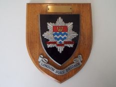 London Fire Brigade - a vintage crested wall plaque mounted on wooden shield, 17.