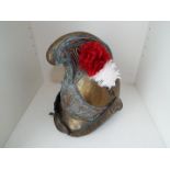 A 19th century French fireman's brass helmet with high comb and side plume socket with red and