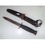 A World War Two (WW2) US Army combat trench knife / dagger with ridge handle in sheath,