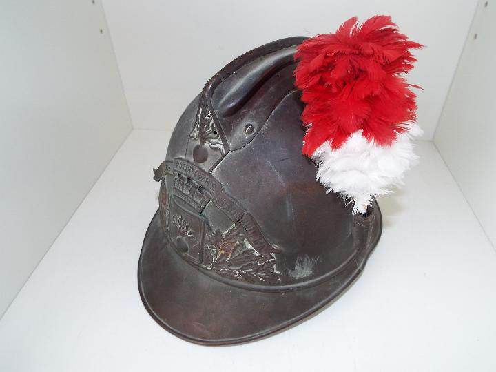 A late 19th / early 20th century French fireman's Adrian pattern brass helmet with side plume