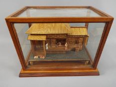 An early 20th century Japanese wood and bamboo work model of a pagoda type house with stand