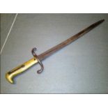 An Imperial German M1871 bayonet for the 1871/84 Mauser Rifle, the bayonet with a brass hilt,