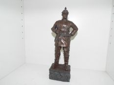 A cold cast bronze military sculpture depicting a World War One (WW1) German Soldier mounted on a