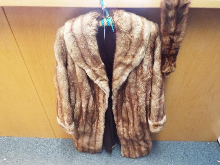 A lady's fur coat, approximately 100 cm