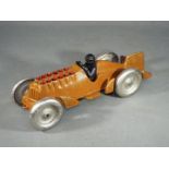 A novelty cast iron racing car with movi