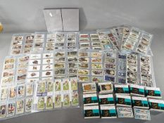 A large collection of cigarette cards, with complete sets, to include Lucky Charms, Roses,