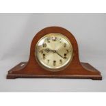 A Napoleons hat mantel clock with carved detailing, Arabic numerals to the dial, with pendulum.